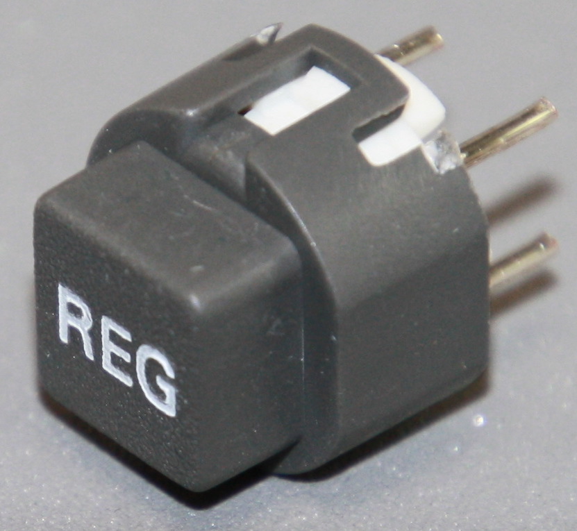 Tryktast med påskrift "REG"