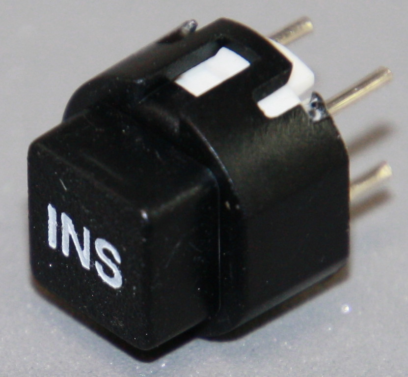 Tryktast med påskrift "INS"